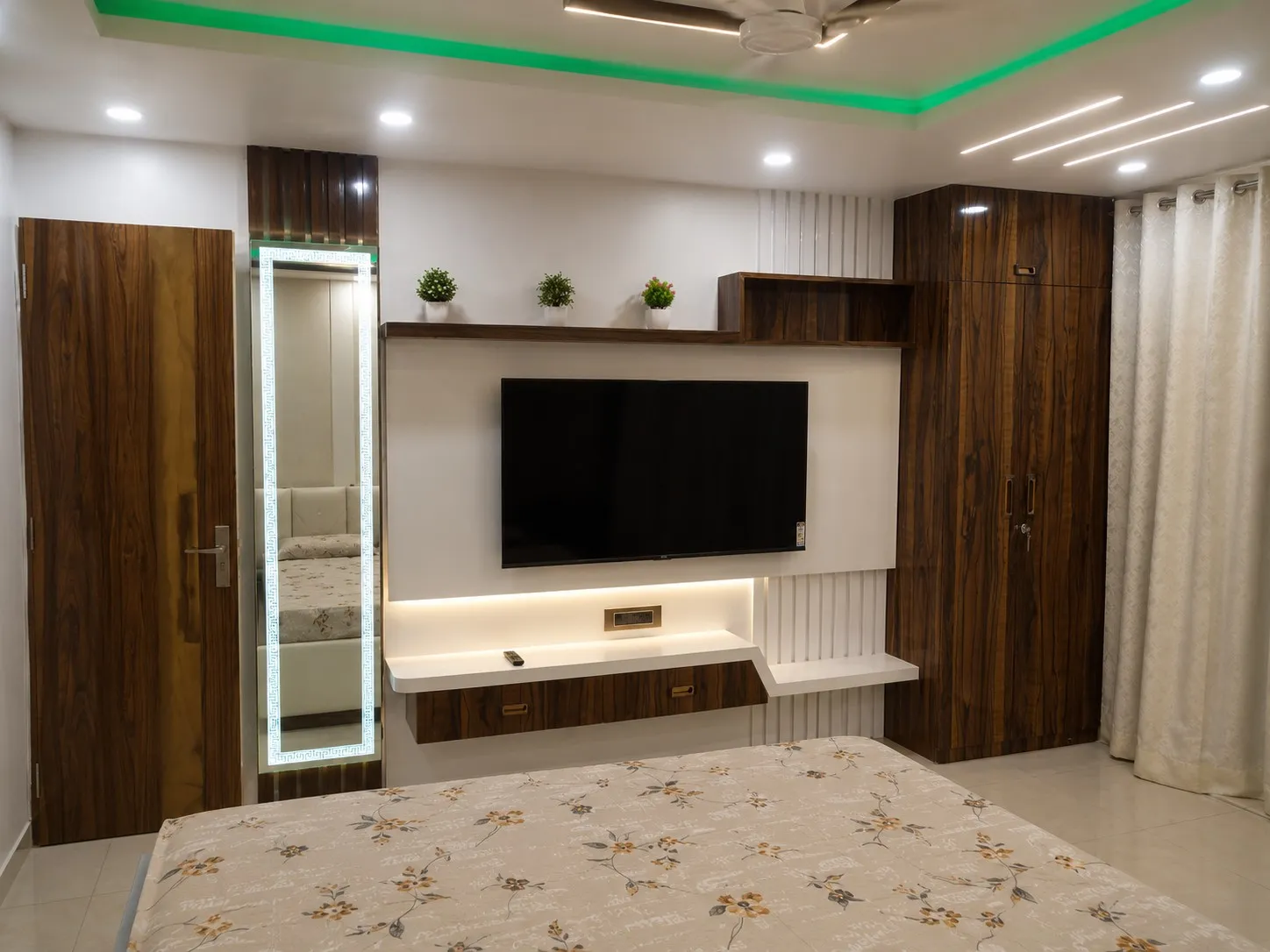 Wall-mounted wooden storage unit and TV console in a bedroom
